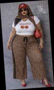 A plus size woman in Leopard print headscarf Red baseball cap (NY logo) White "CHERRY" graphic crop top Leopard print wide-leg track pants with side stripes Red pointed-toe pumps Red leather shoulder bag Oversized square sunglasses Gold heart pendant necklace Gold bangle bracelets
