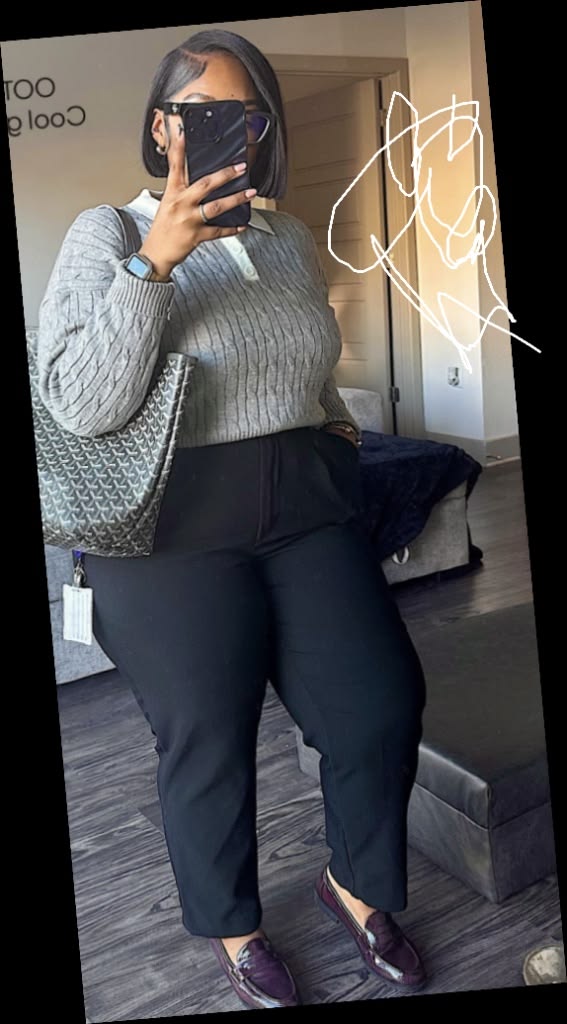 A plus size woman in Grey cable-knit sweater with white collar detail Black high-waisted trousers Deep purple/burgundy patent leather loafers Black and grey patterned tote bag Smartwatch and black-rimmed glasses