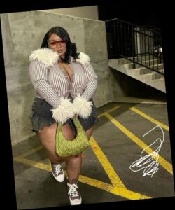 A plus size woman in Faux Fur Cardigan & Denim Skirt