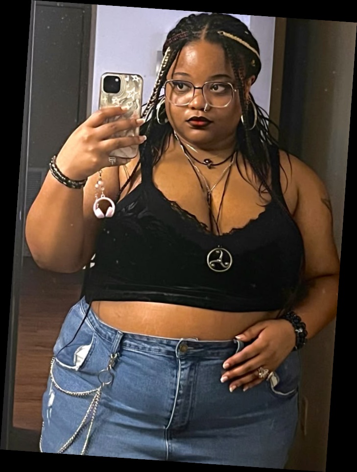 Ideal summer outfit for plus size women 5 A plus size woman wearing Black velvet lace-trim crop top with silver pendant Medium wash denim mini skirt Silver multi-strand hip chains Clear-frame glasses Black beaded bracelets Silver hoop earrings