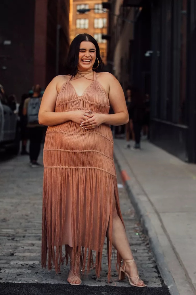 Ideal summer outfit for plus size women 2 A woman wearing Rose-gold macramé fringe midi dress with halter neck Nude strappy heeled sandals Gold oversized hoop earrings Gold rings