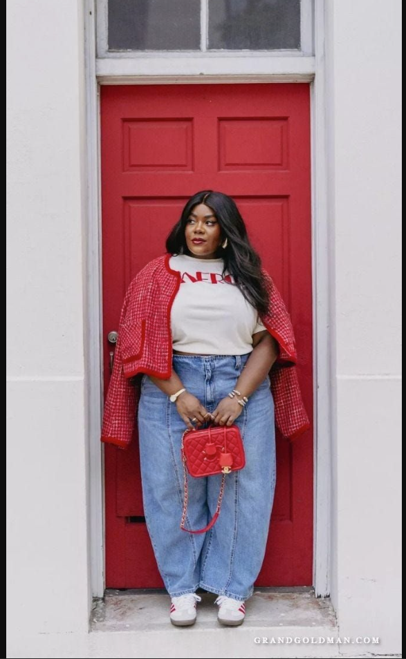 A plus size woman wearing Red and white tweed cropped blazer jacket

White crewneck T-shirt with red graphic text

Light wash high-waisted wide-leg denim jeans with center seams

Red quilted leather crossbody bag with chain strap

White casual sneakers with red stripes