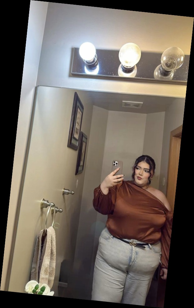 For the baddie girlies, here are some ways to eat up that baddie look 8 A woman with Copper satin one shoulder top Light blue wide leg jeans Black thin belt