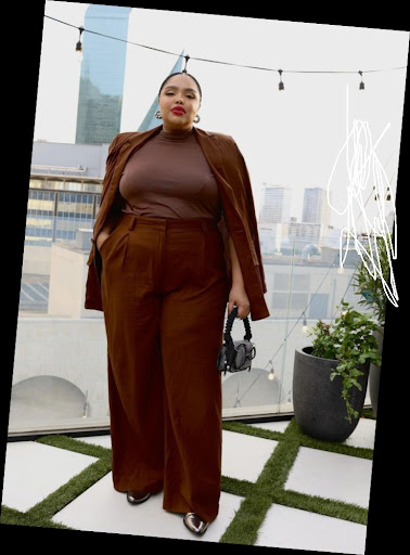 Some Chic Office Outfits for Plus Size Queens, style with class! 11 A plus size woman in Chocolate brown oversized blazer (draped over shoulders) Chocolate brown mock-neck top Matching chocolate brown wide-leg trousers Small black ruched handle bag Metallic pointed-toe flats/heels Silver statement earrings