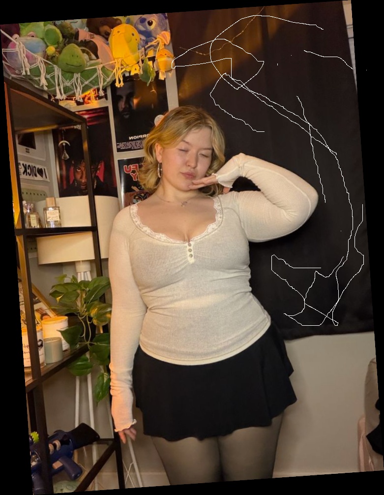 Ideal summer outfit for plus size women 7 A plus size woman wearing Cream long-sleeve thermal top with lace trim and buttons Black skater-style mini skirt Sheer black tights Silver hoop earrings Gold pendant necklace