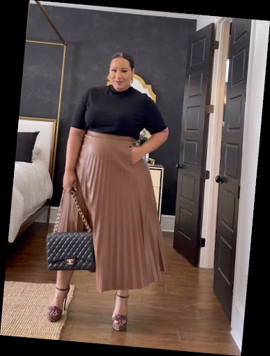 Some Chic Office Outfits for Plus Size Queens, style with class! 7 A plus size woman in Black mock-neck short-sleeve top Tan/Camel faux leather pleated midi skirt Black quilted designer handbag with gold chain Leopard print platform sandals Gold hoop earrings
