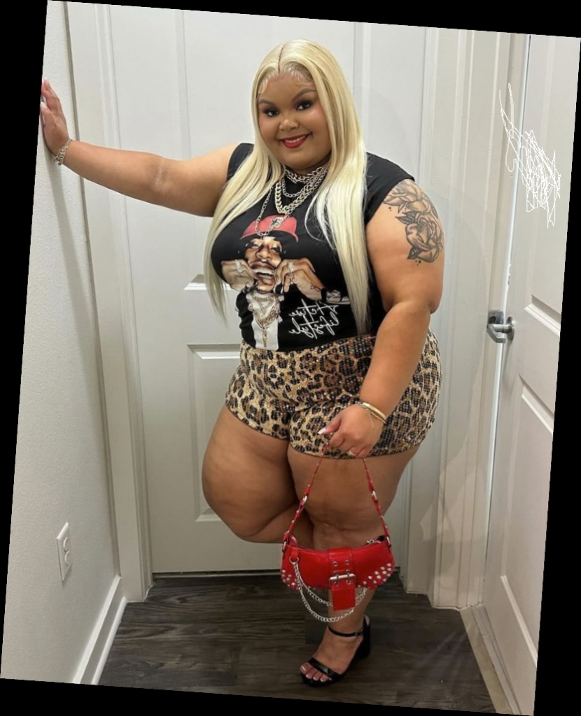 Right here are some pretty much affordable outfits for every plus size queen 8 A plus size woman wearing Black sleeveless graphic t-shirt Leopard print denim shorts Small red studded handbag with chain Black block-heel sandals Layered silver chunky chain necklaces Gold bracelets