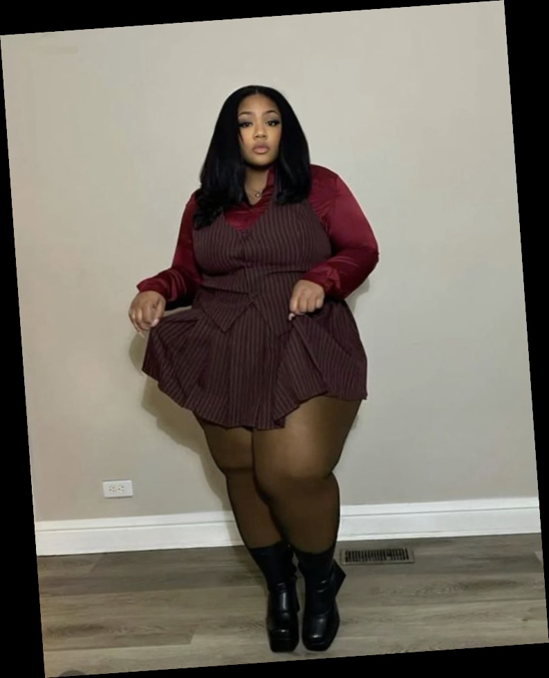 For this fall, I put together this list of some awesome fits for the beautiful plus size queens 2 A plus size woman wearing Burgundy satin long sleeve button-down shirt Burgundy pinstripe vest and pleated mini skirt set Sheer black tights Black platform ankle boots Gold pendant necklace