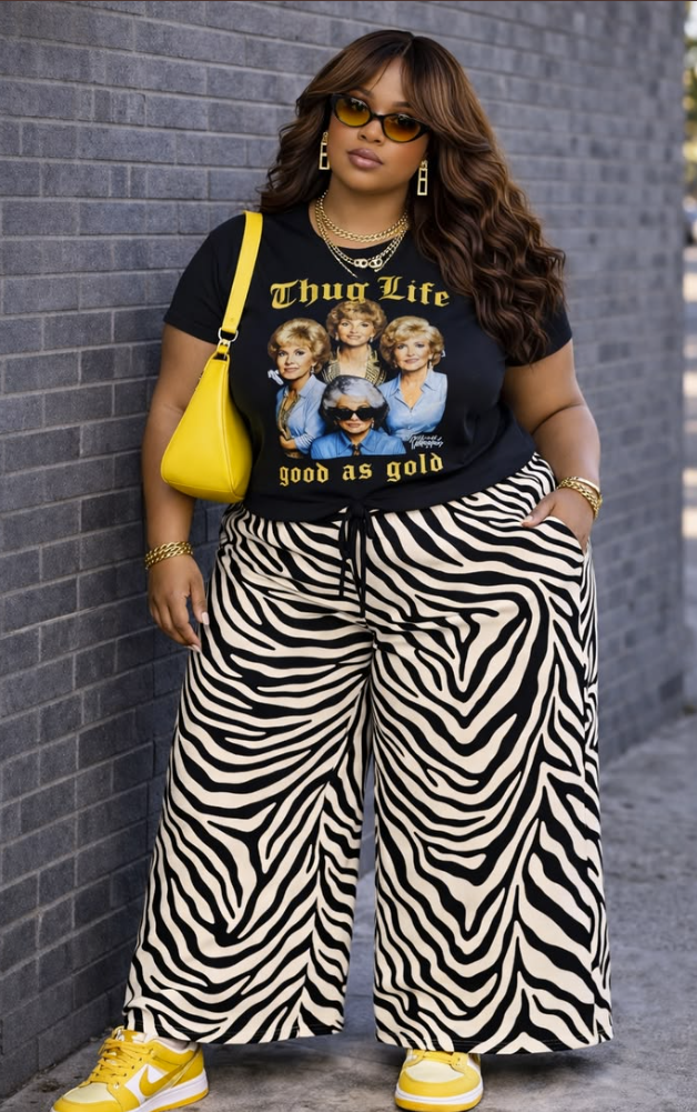 Sun-Ready Summer Vacation Outfits for Plus Size Women 3 A plus size woman wearing Black graphic t-shirt featuring The Golden Girls with text "Thug Life" Zebra print wide-leg drawstring pants Yellow and white leather low-top sneakers Bright yellow leather shoulder bag Gold chunky chain link necklaces Gold chain link bracelets Yellow-tinted aviator sunglasses Gold geometric drop earrings