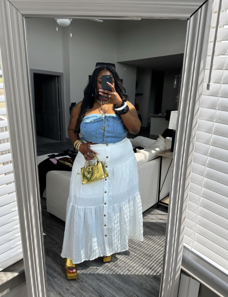 Sun-Ready Summer Vacation Outfits for Plus Size Women 9 A plus size woman wearing Medium wash strapless denim corset top with front buttons White tiered cotton maxi skirt with front buttons Gold metallic mini top-handle bag Gold metallic platform block heel sandals Black sunglasses (worn on head) Gold layered chain necklaces Chunky white and gold bangle bracelets