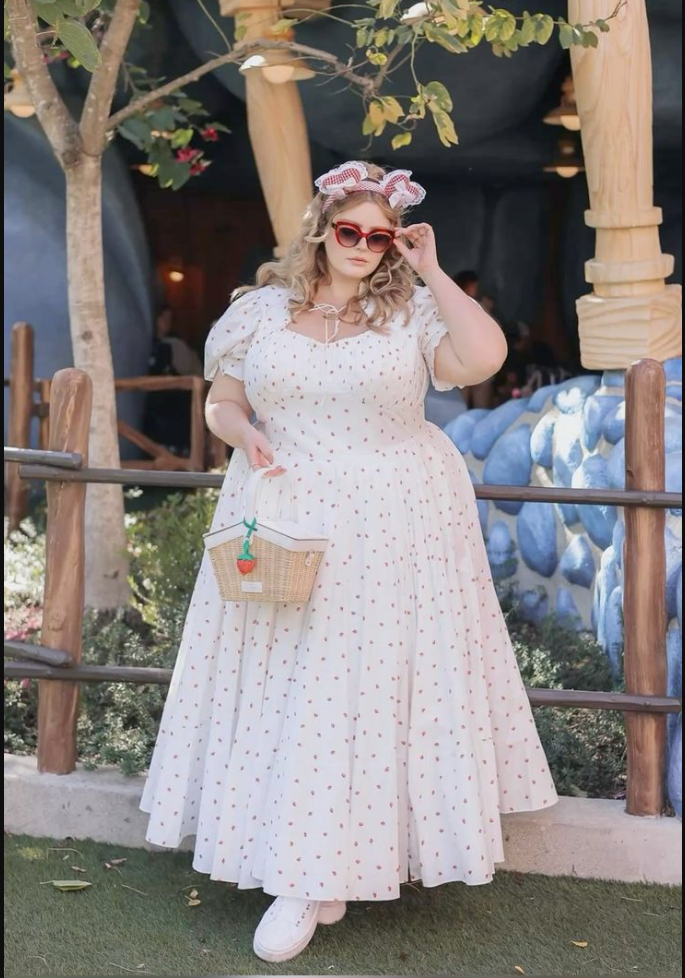 A plus size woman wearing White strawberry print puff sleeve maxi dress

Red cat-eye sunglasses

Red and white gingham bow headband

Woven wicker picnic basket bag with strawberry charm

White low-top platform sneakers