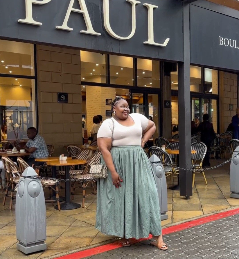 Skirt Season Forever: Flattering Skirt Outfits for Plus Size Women 7 A plus size woman wearing White scoop neck t-shirt
Light sage green patterned midi skirt
Patterned crossbody bag
Gold hoop earrings
Beige slide sandals