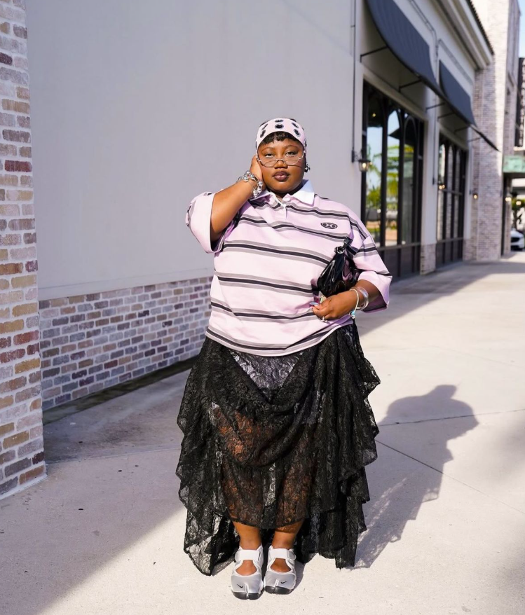 Skirt Season Forever: Flattering Skirt Outfits for Plus Size Women 10 A plus size woman wearing Pink and black striped polo shirt
Black lace hi-low skirt
Polka dot baseball cap
Black handbag
White Mary Jane shoes
Silver watch and bracelets