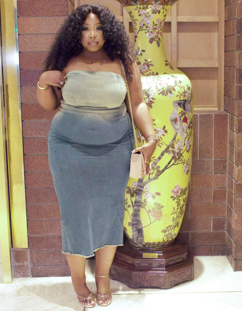 Daytime Charm: Cute & Comfortable Lunch Outfits for Plus Size Women 4 A plus size woman wearing Light-wash denim strapless midi dress Gold chain-strap shoulder bag Gold hoop earrings Gold bracelets and rings Nude strappy heeled sandals Gold anklet