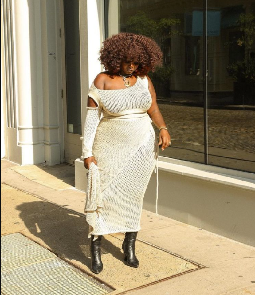 Daytime Charm: Cute & Comfortable Lunch Outfits for Plus Size Women 2 A plus size woman wearing See how this creamy knit midi dress hugs her beautifully, creating the most flattering silhouette while keeping things cool and breathable for a sunny lunch date. The off-shoulder detail and matching arm warmers add such an artistic, bohemian touch that feels effortlessly elegant. You can tell it’s perfect for those warm spring-to-summer lunch outings — pair it with sleek boots like she did and you’ll feel confident, stylish, and ready to enjoy every bite.