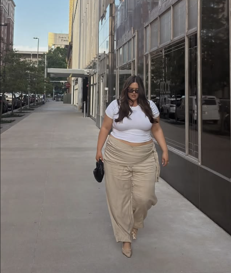 A plus size woman wearing White crop top
Beige ruched wide leg pants
Leopard print pointed toe heels
Black handbag
Black sunglasses
