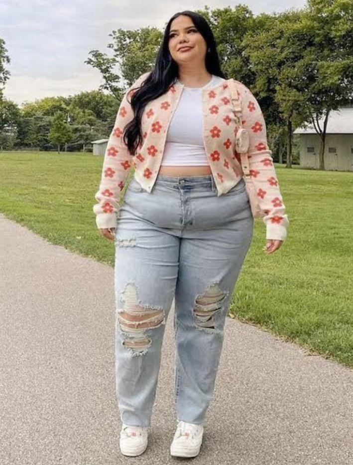 A plus size woman wearing Floral knit cardigan
White ribbed crop top
High-waisted ripped mom jeans
White platform sneakers
Mini crossbody bag