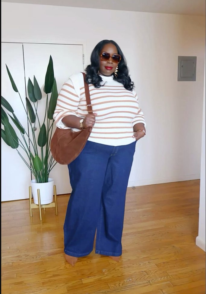 A plus size woman wearing White and brown striped long-sleeve top
Dark blue wide-leg jeans
Brown suede shoulder bag
Tortoise shell sunglasses