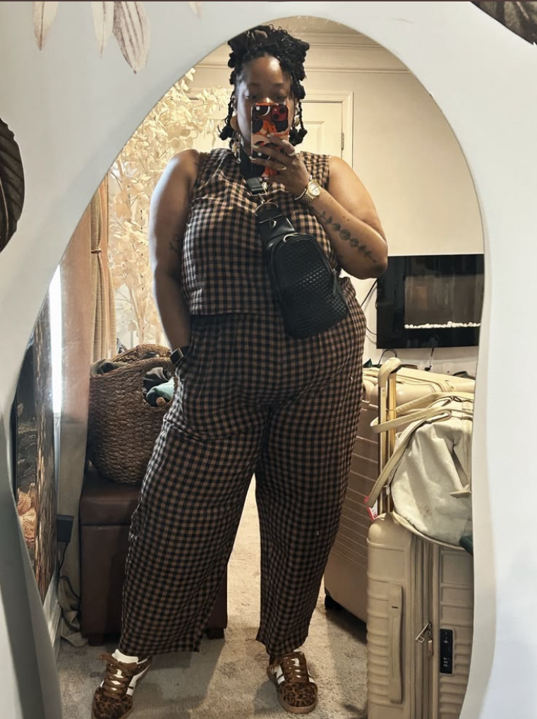 A plus size woman wearing Brown and black gingham sleeveless top
Brown and black gingham wide-leg pants
Black crossbody bag
Leopard print sneakers
Gold watch