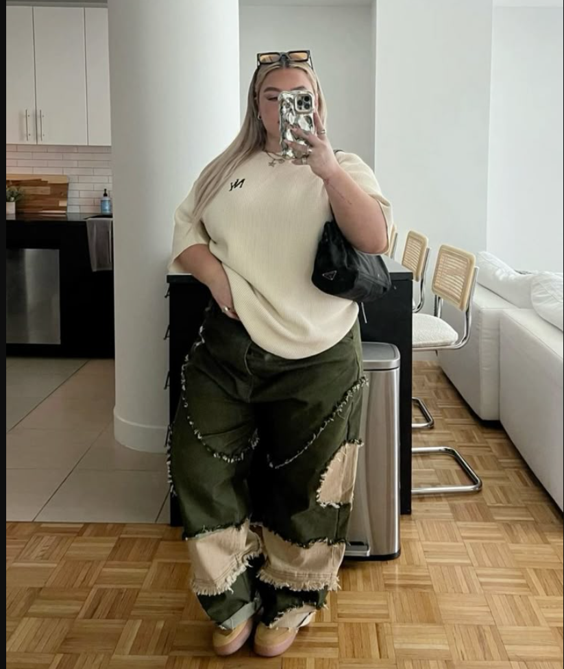 A plus size woman wearing Cream short-sleeve knit sweater
Green patched cargo pants
Black crossbody bag
Sunglasses on head
