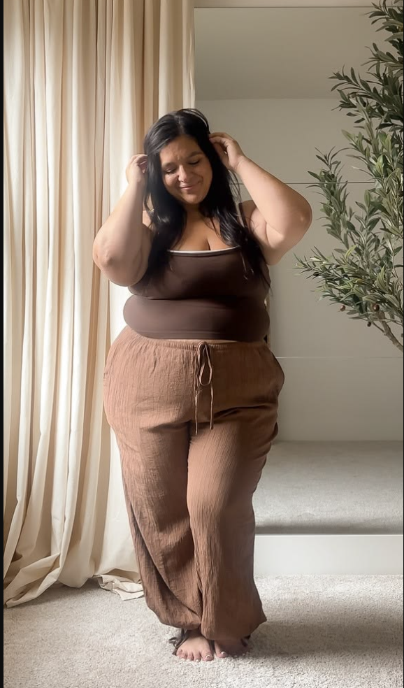 A plus size woman wearing Brown double-layer tank top Brown drawstring wide-leg crinkle pants